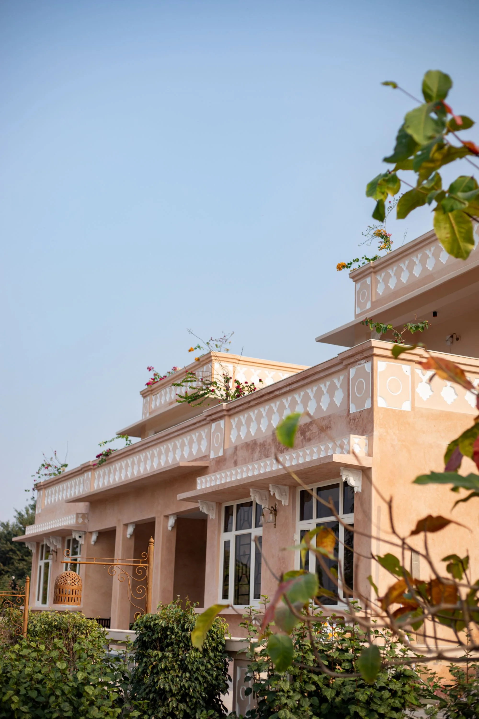 The upper terrace balustrade and columned veranda seen from the garden path