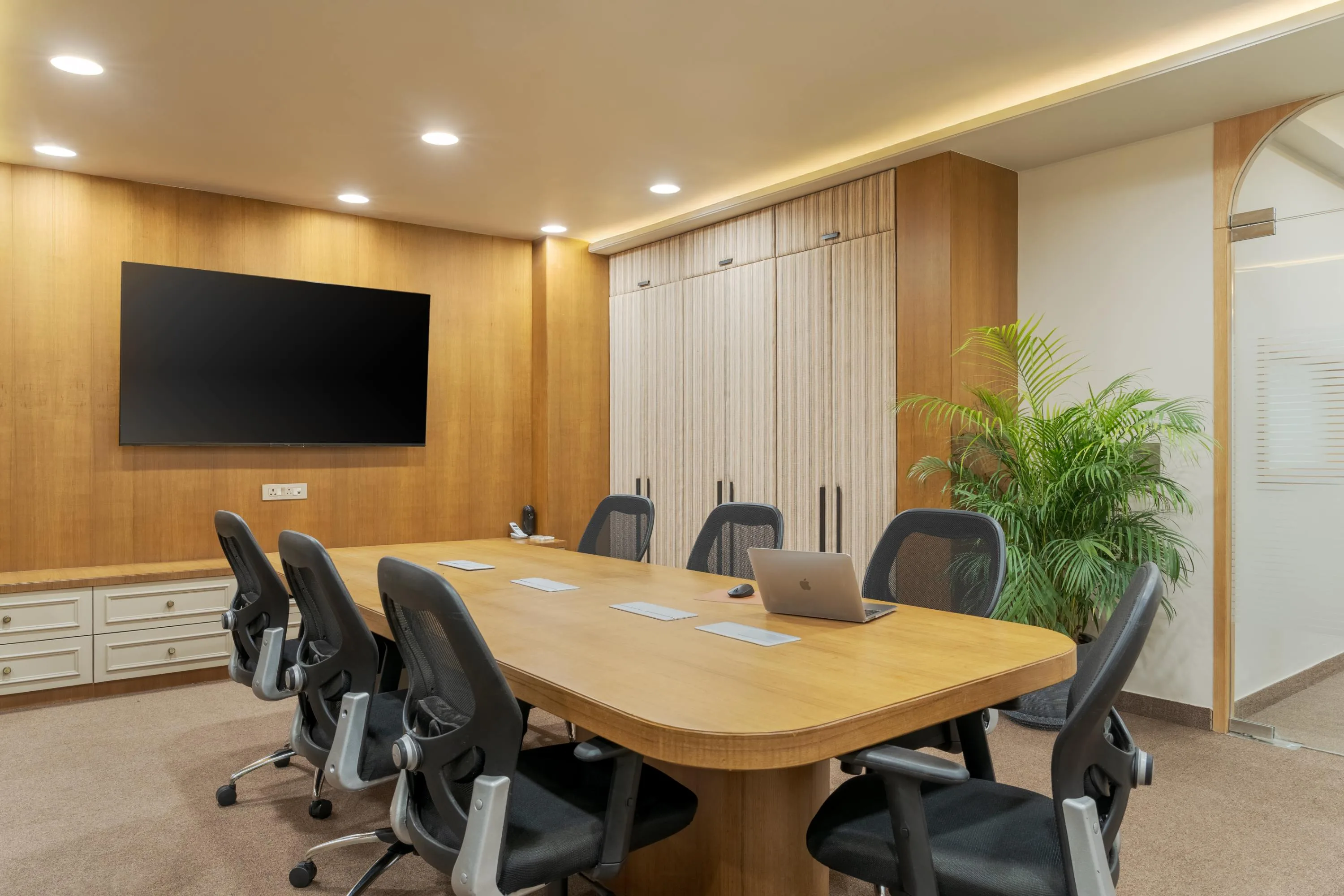 Boardroom corner with striped wardrobe cabinetry and glazed entrance beyond