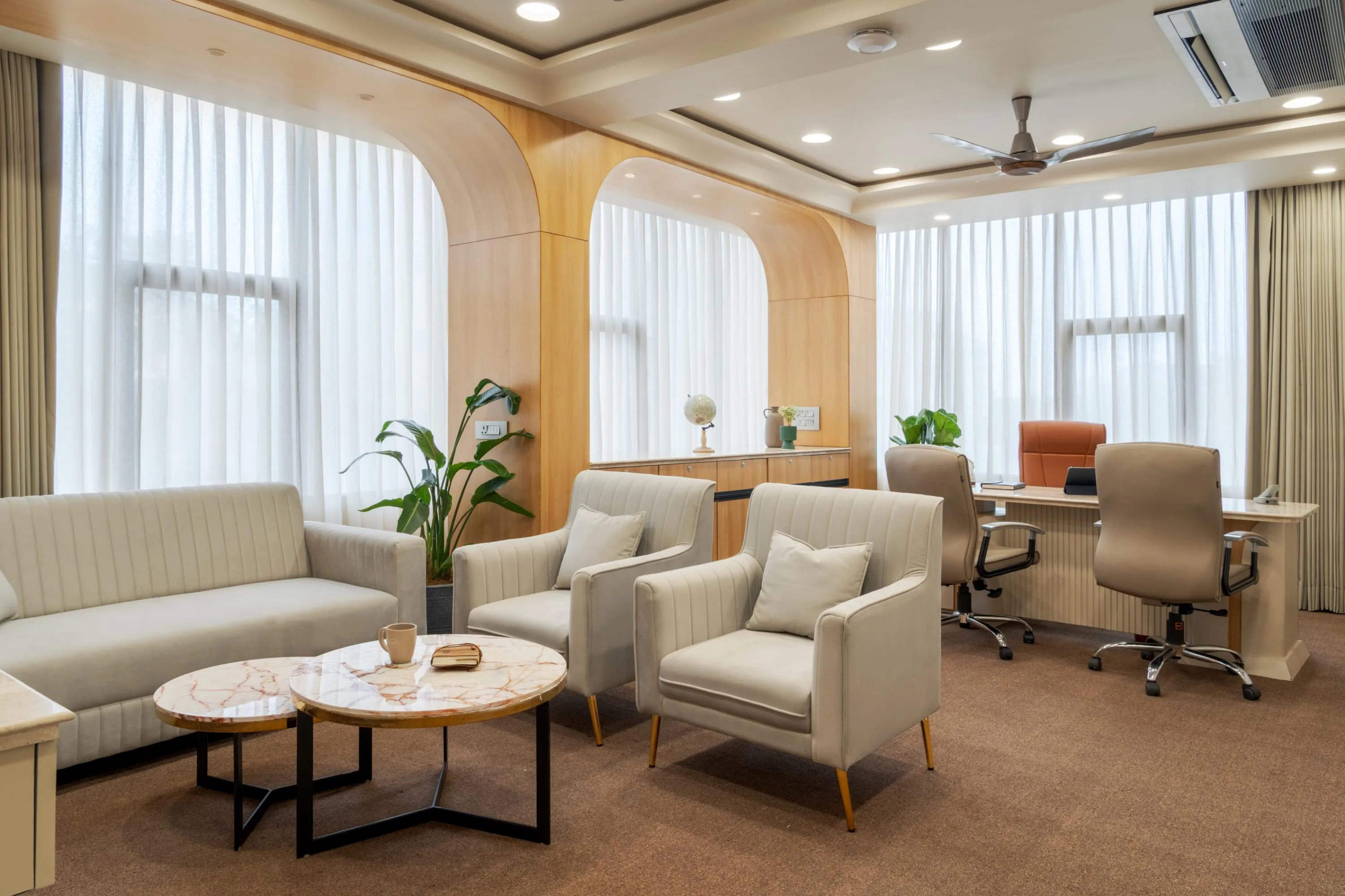 Reception lounge seating with a marble coffee table, cabin visible beyond