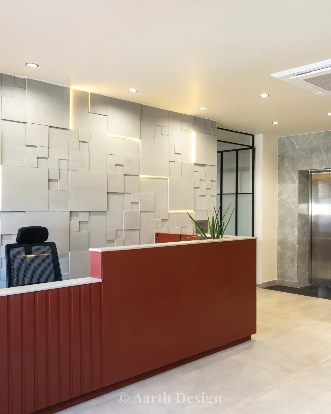 Reception desk in fluted red timber before a lit, textured stone-tile wall