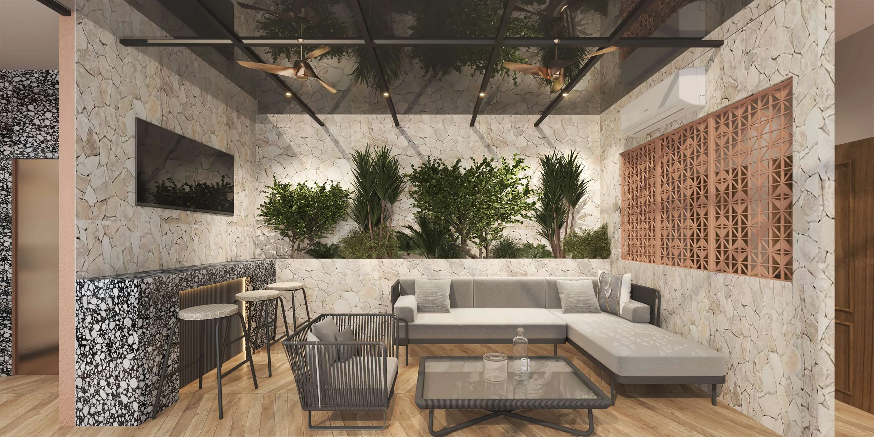 Indoor-outdoor lounge with potted greenery against a stone wall