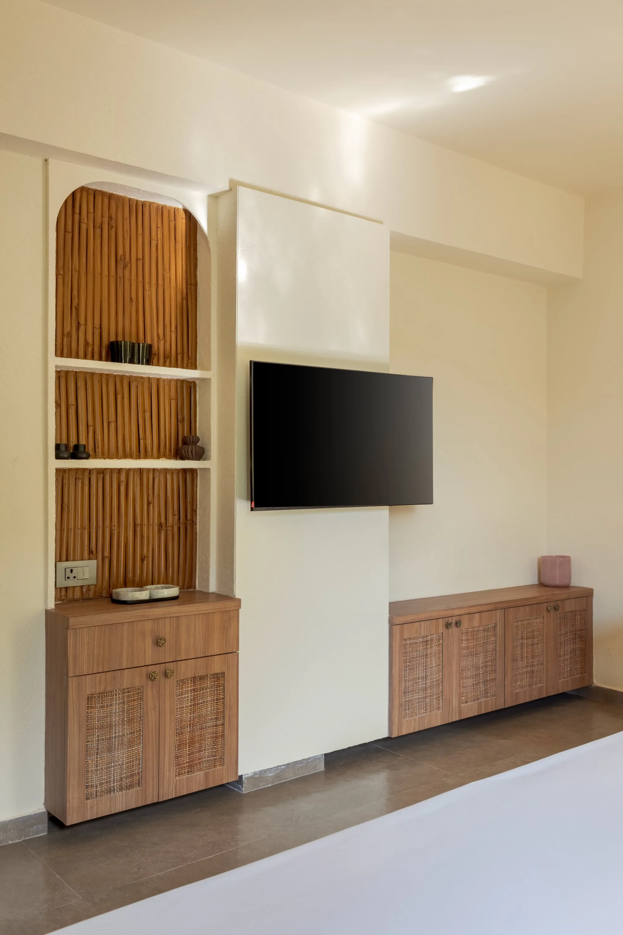 Bedroom with a bamboo-shelved alcove beside the television wall