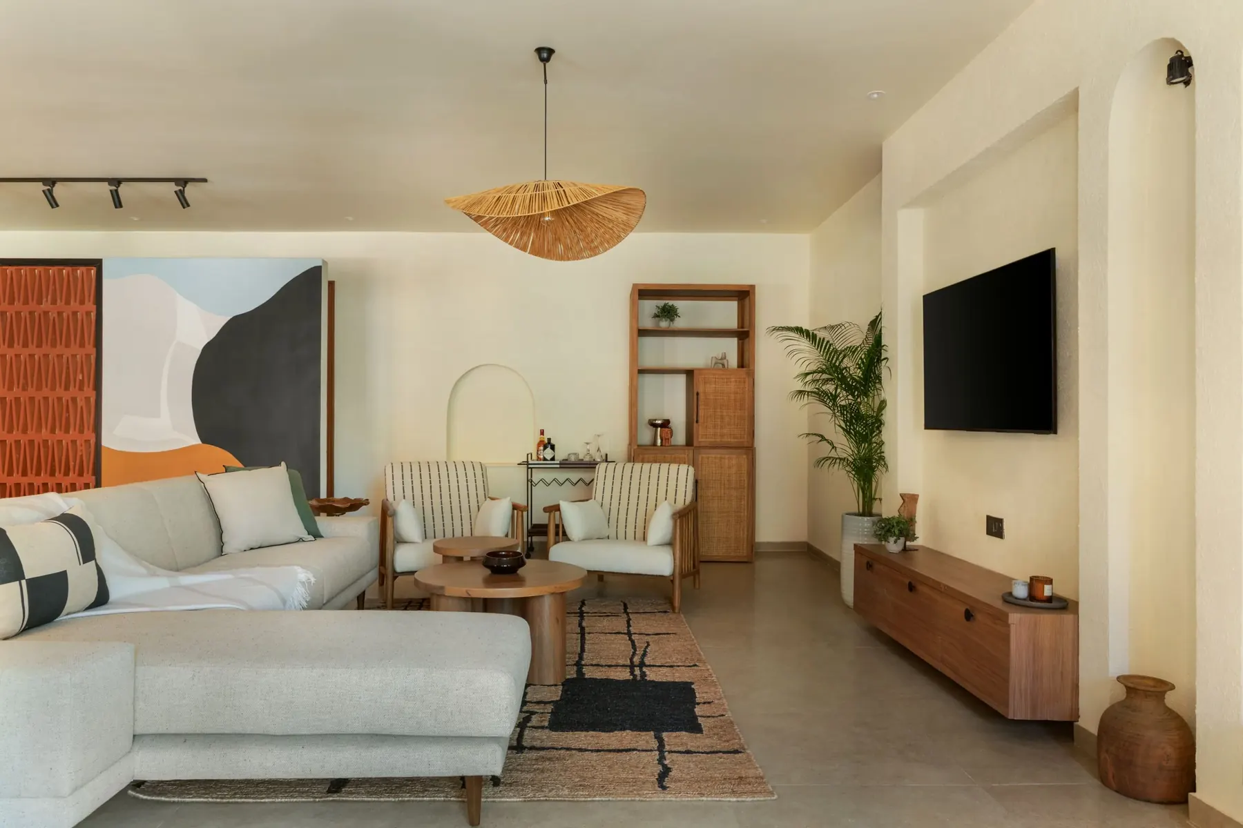 Living room with a sectional sofa and a bold abstract mural