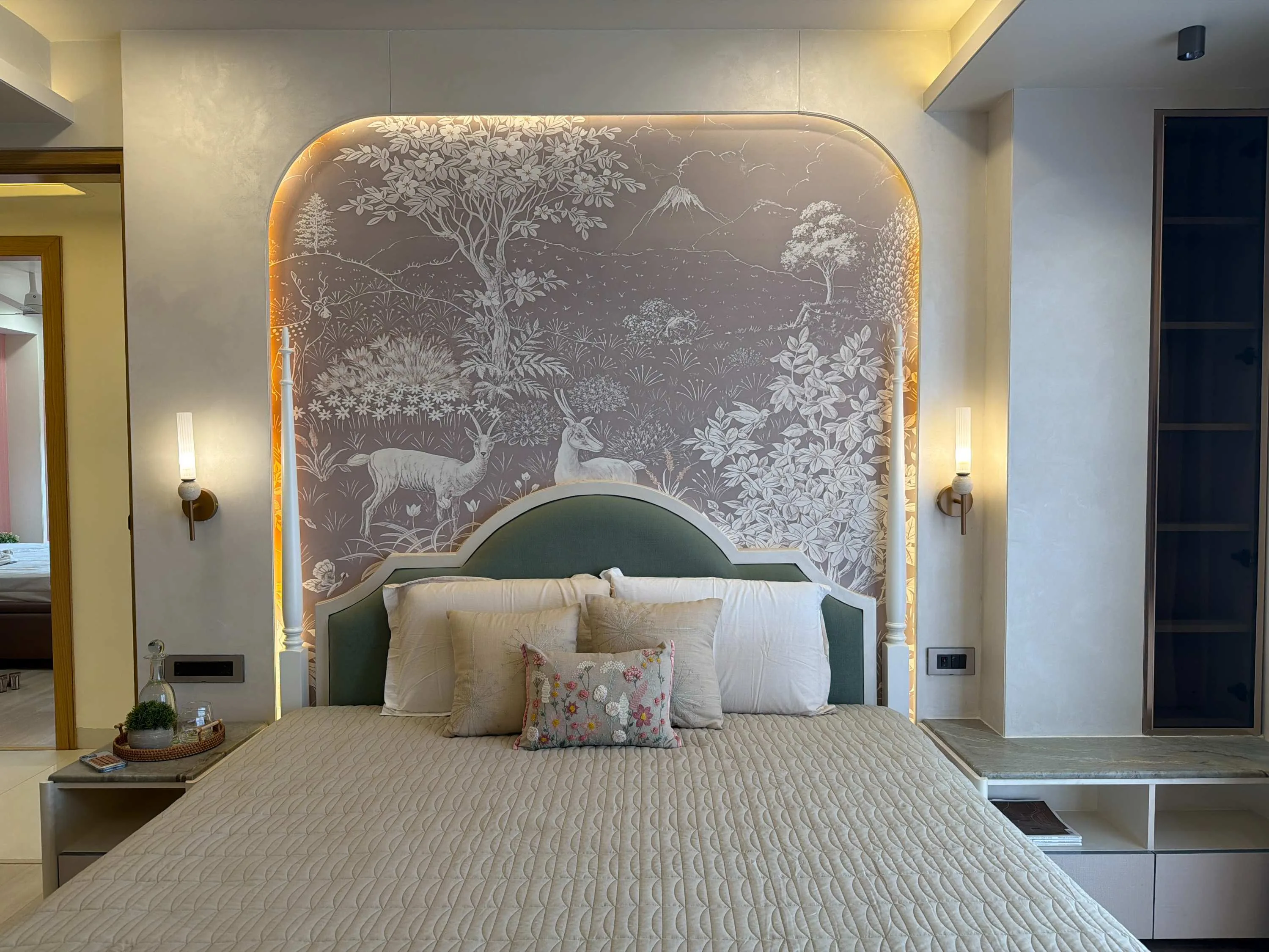 Primary bedroom with a hand-painted deer-and-floral mural set in an arched niche behind the headboard