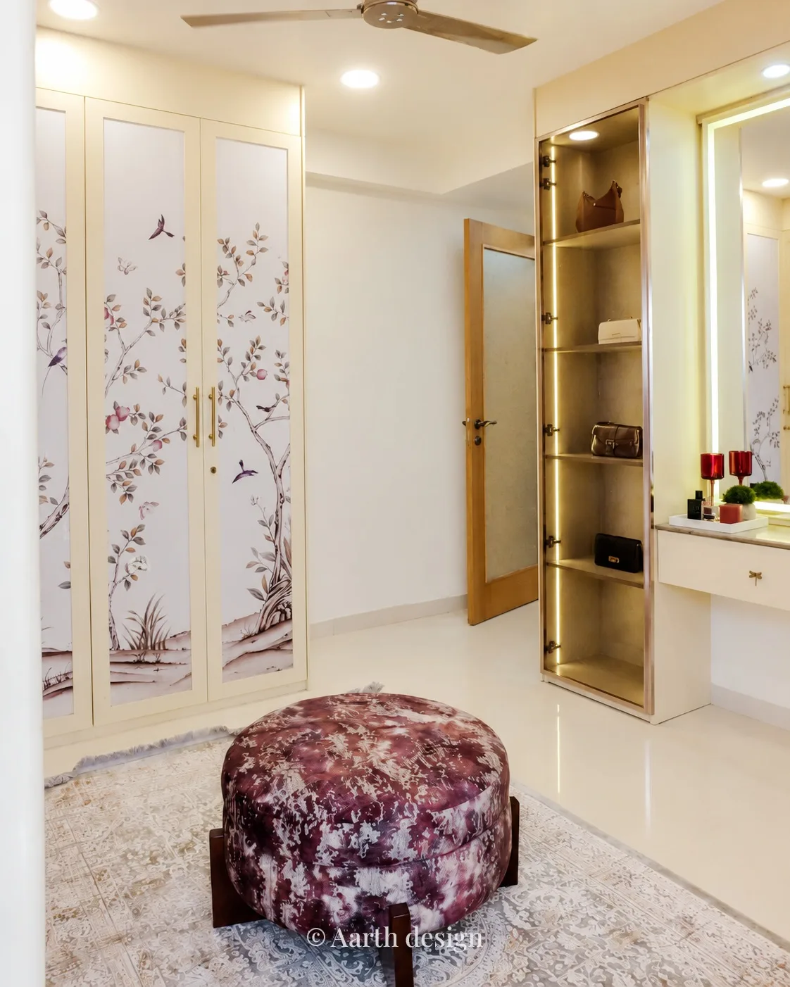 Dressing room with hand-painted botanical wardrobe doors and a velvet pouffe