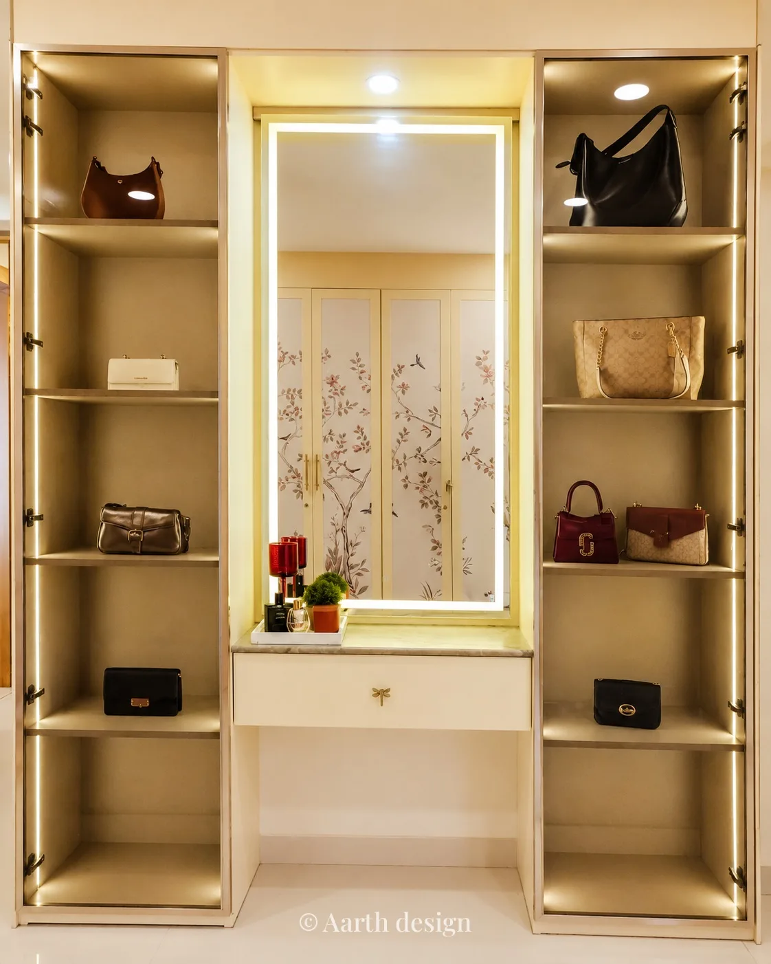 Dressing room with a lit mirror console flanked by open, illuminated handbag shelving