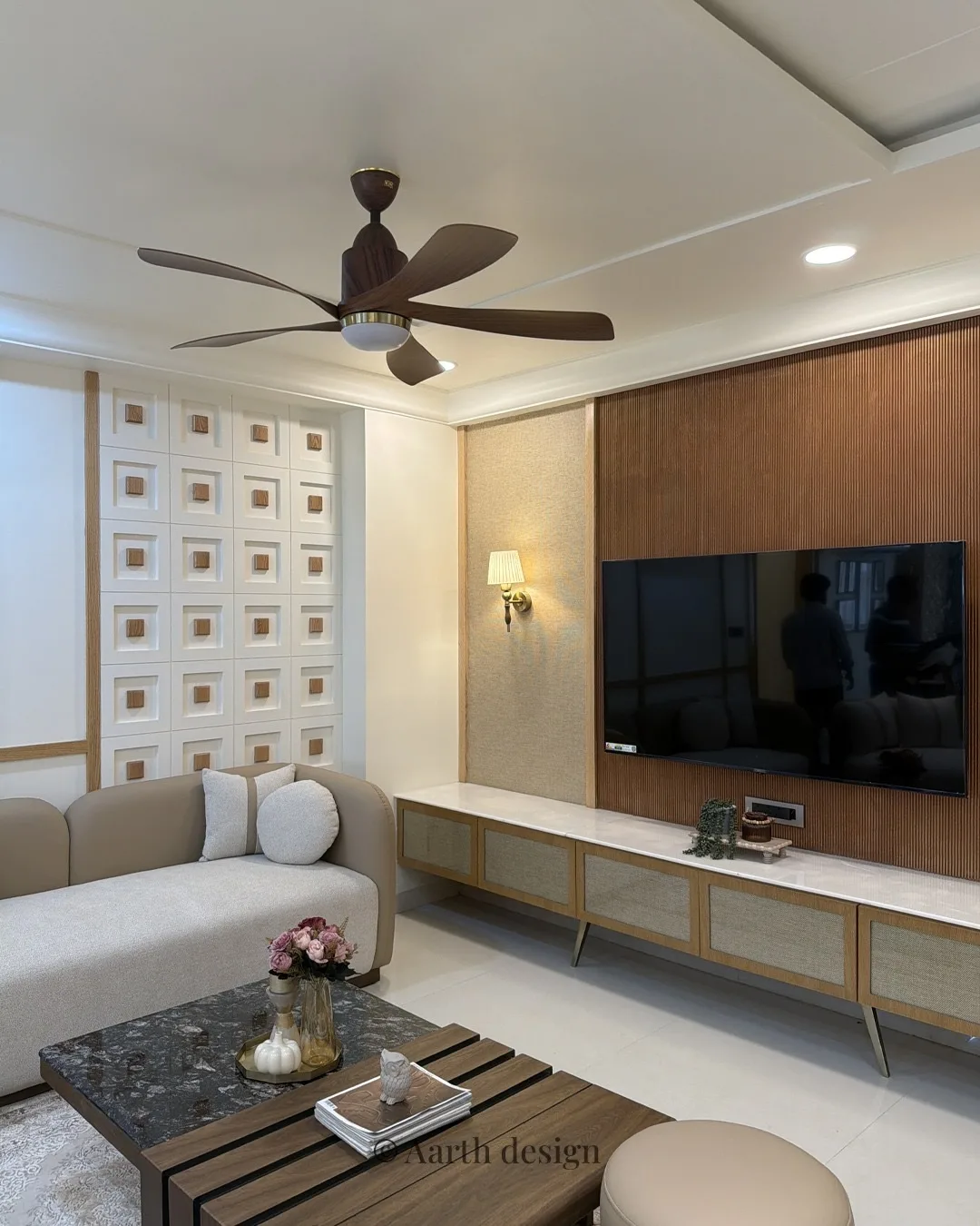 Living room with a walnut-slatted television wall and a floating oak console